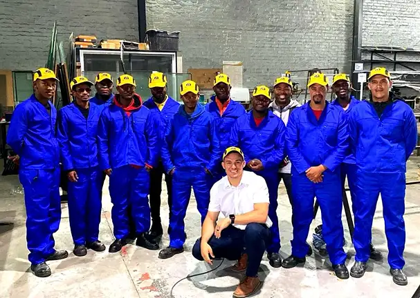 Group of mean in blue overalls at bright home warehouse