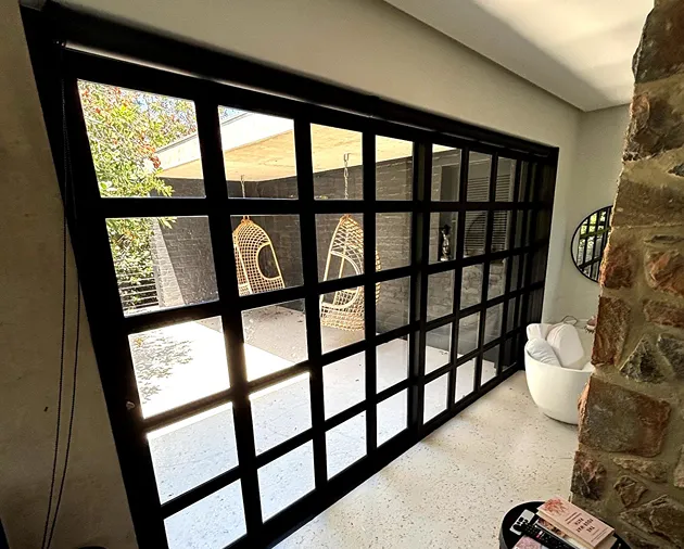 sleek black premium sliding‐door system with matching sliding windows